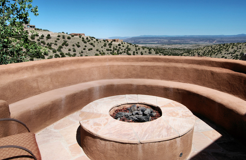 Example of a southwest backyard patio design in Portland with a fire pit and no cover