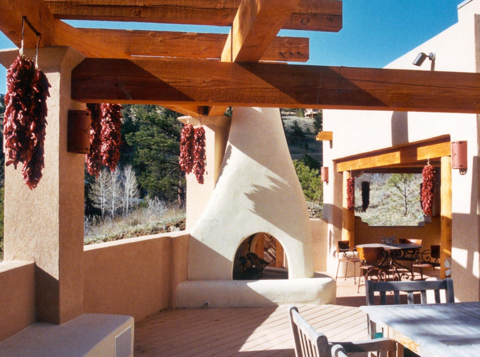 Inspiration for a large back patio in New York with a fire feature, decking and a pergola.