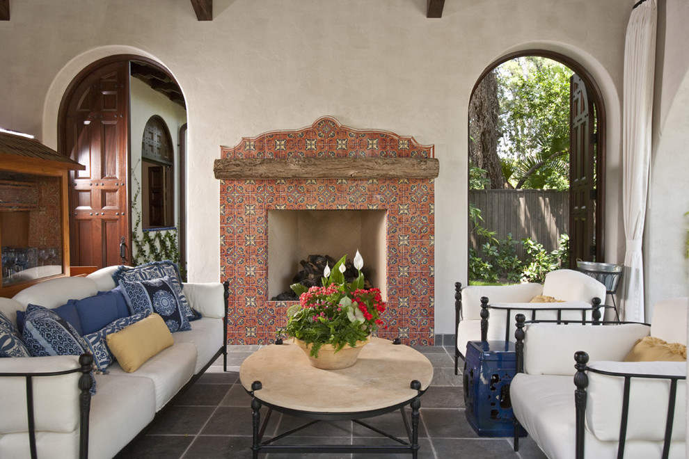 Example of a southwest tile patio design in Houston with a fire pit