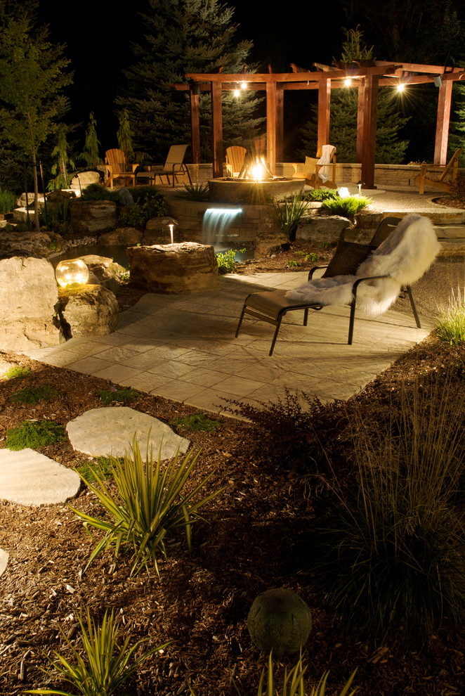Inspiration for a large world-inspired back patio in Montreal with a water feature, concrete paving and a pergola.