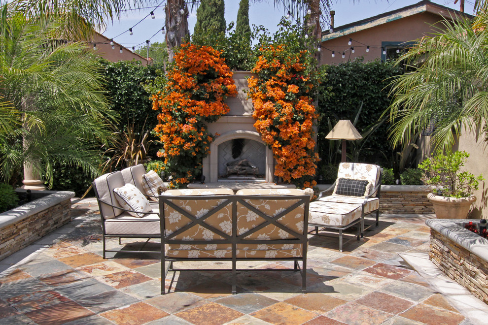 Inspiration for a mediterranean courtyard patio in Orange County with a fire feature.