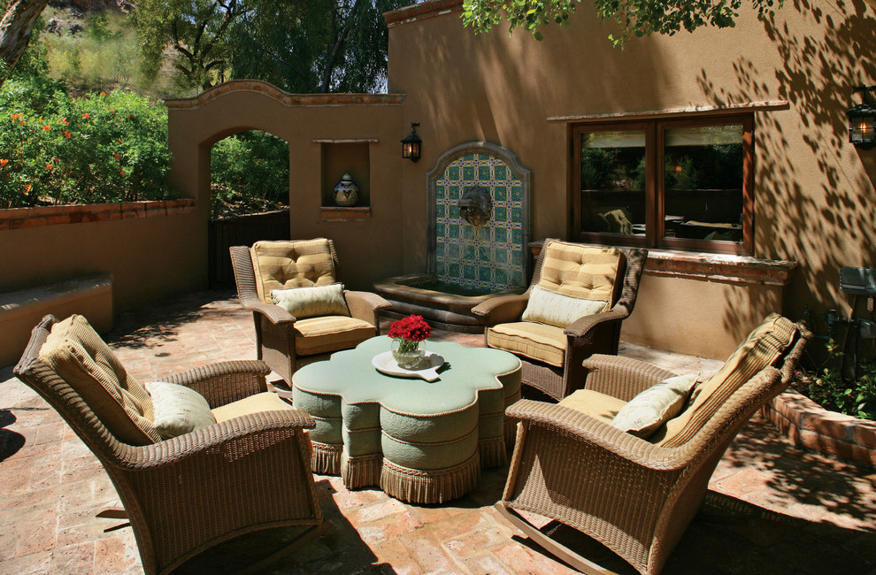 Diseño de patio de estilo americano con adoquines de ladrillo y fuente