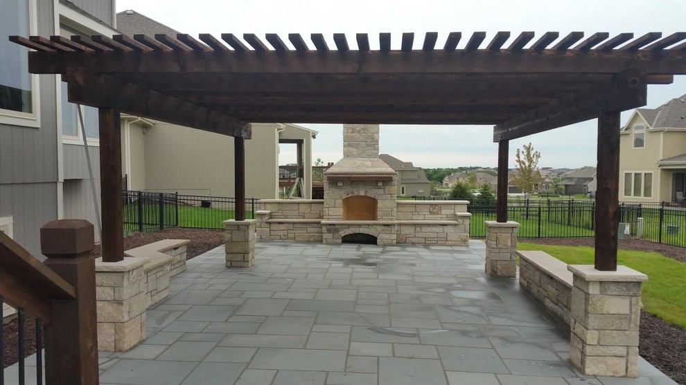 Mid-sized transitional backyard concrete paver patio photo in Kansas City with a fire pit and a pergola