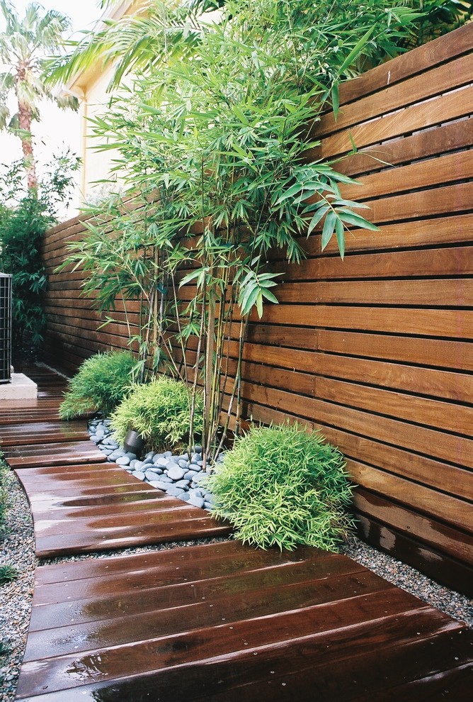 Modelo de patio de estilo zen de tamaño medio sin cubierta en patio trasero con entablado