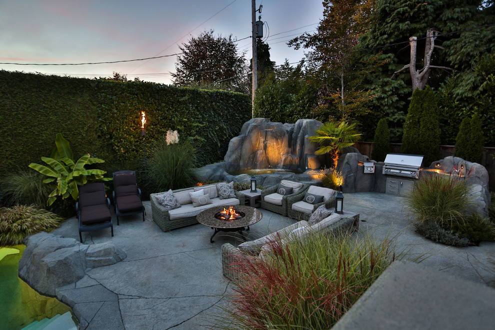 Patio fountain - large traditional backyard stamped concrete patio fountain idea in Vancouver