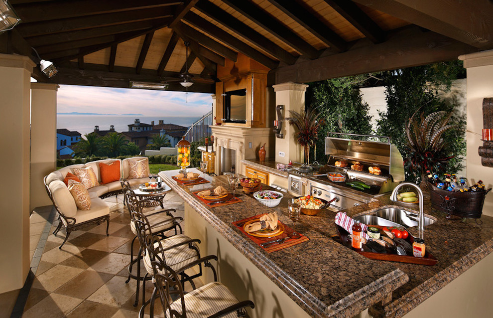 Cette photo montre une grande terrasse arrière chic avec une cuisine d'été et un gazebo ou pavillon.
