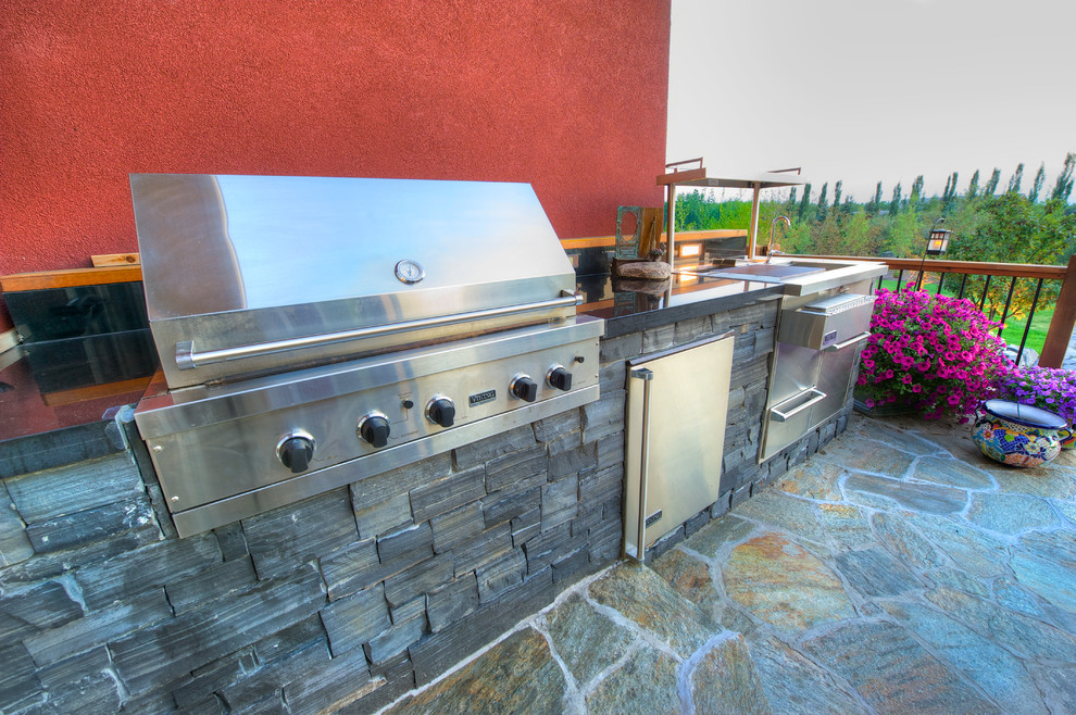 Classic back patio in Calgary with an outdoor kitchen.