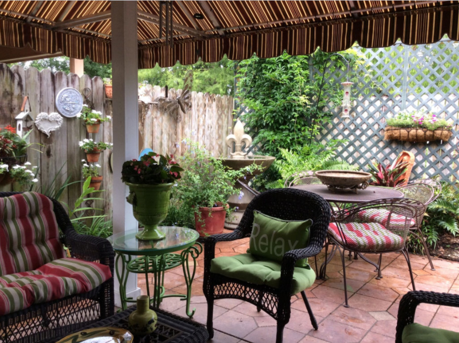 Imagen de patio tradicional de tamaño medio en patio trasero con cocina exterior, suelo de baldosas y toldo