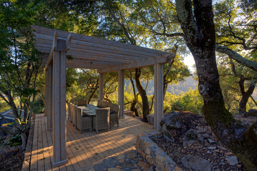 Photo of a large farmhouse back patio in San Francisco with a pergola.