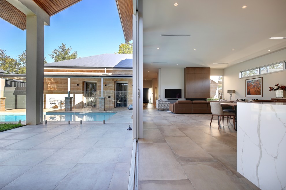 Photo of a large contemporary back patio in Adelaide with tiled flooring and a roof extension.