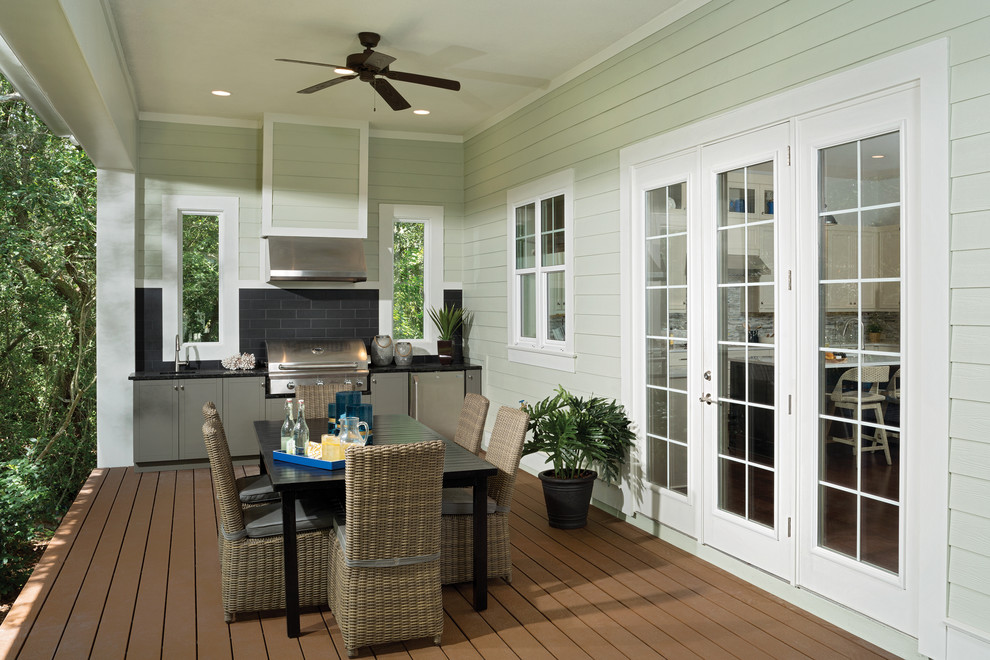 Design ideas for a large beach style back patio in Tampa with an outdoor kitchen, decking and a roof extension.