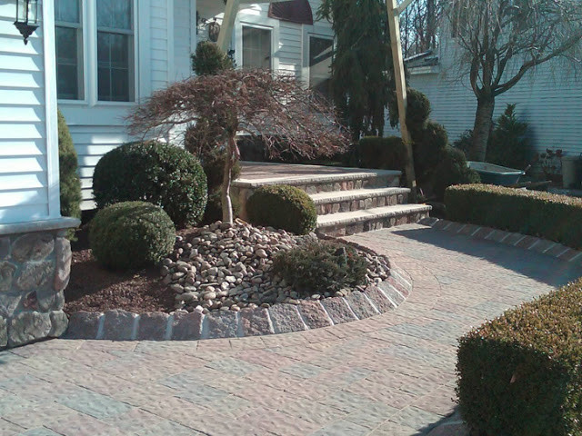 Patio - mid-sized front yard stone patio idea in New York with no cover