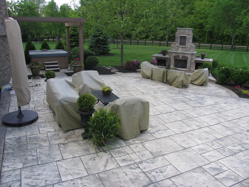 Example of a large classic backyard concrete paver patio design in Columbus