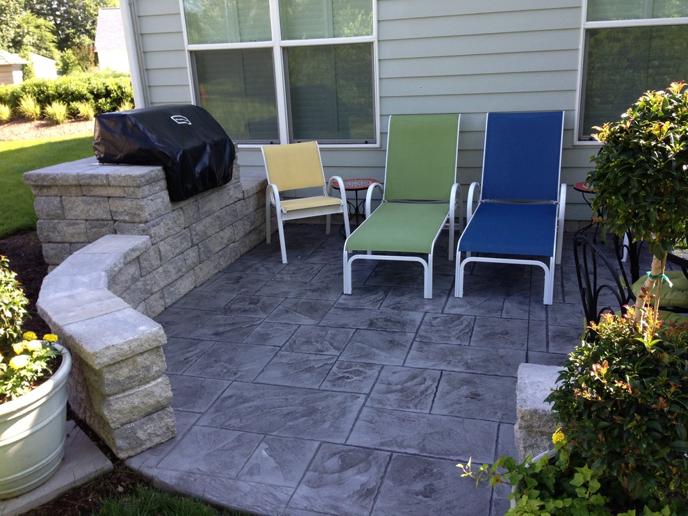 Stamped concrete patio with seating wall and built in grill Patio