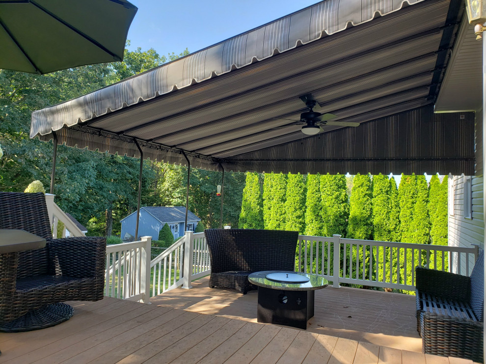 Inspiration for a large classic back patio in Philadelphia with an awning.