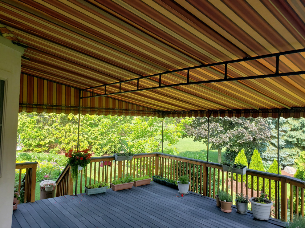 Design ideas for a large classic back patio in Philadelphia with an awning.