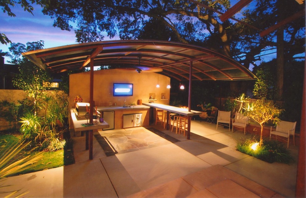 This is an example of a large modern back patio in Sacramento with a fire feature, tiled flooring and a pergola.