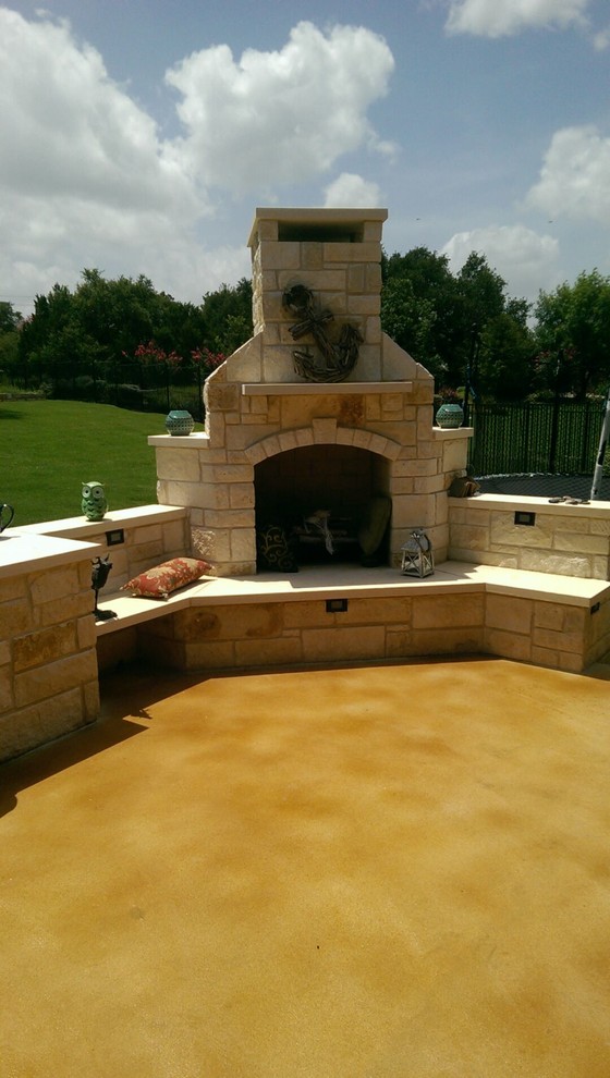 Photo of a medium sized rustic back patio in Austin with a fire feature, concrete slabs and no cover.