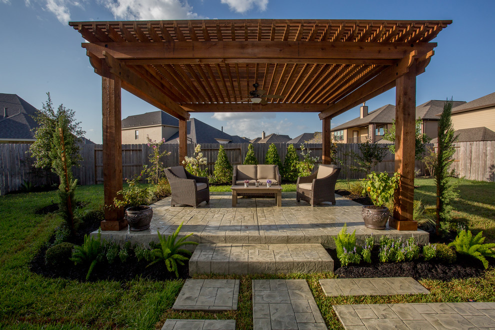 Example of a classic backyard patio design in Houston with a pergola