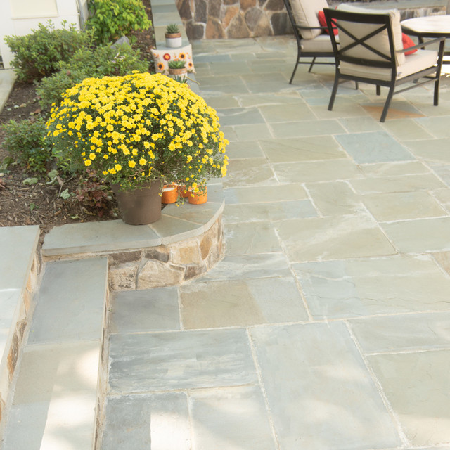 Stone backyard chimney, patio, retaining walls, outdoor kitchen, and