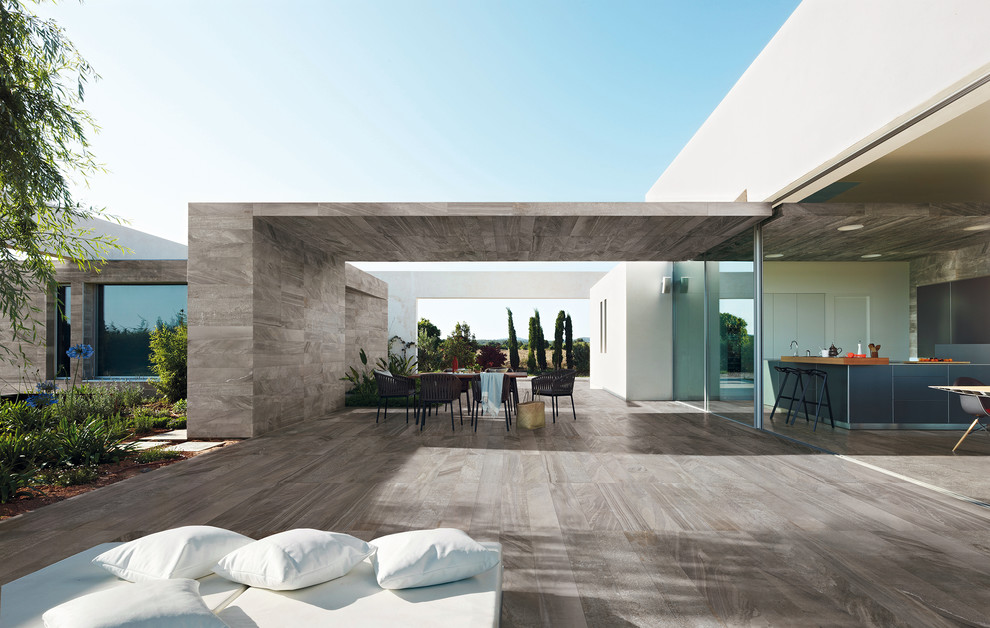 Inspiration for a large contemporary back patio in San Francisco with tiled flooring and a roof extension.