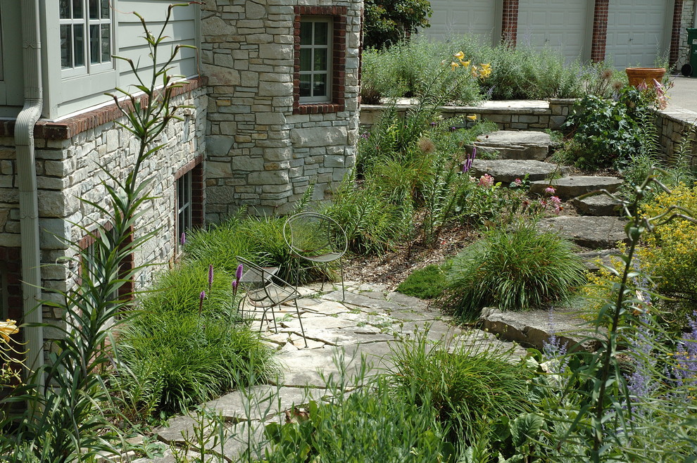 Example of a classic stone patio design in Detroit with no cover