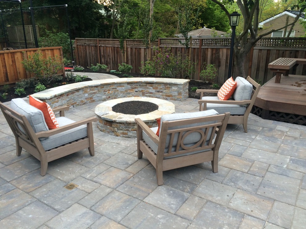 Medium sized traditional back patio in Other with a fire feature, stamped concrete and no cover.