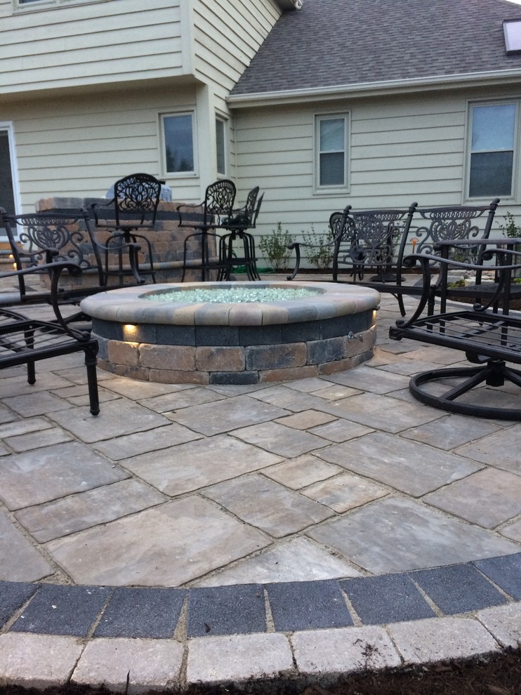 Design ideas for a medium sized classic back patio in Chicago with a fire feature, natural stone paving and no cover.