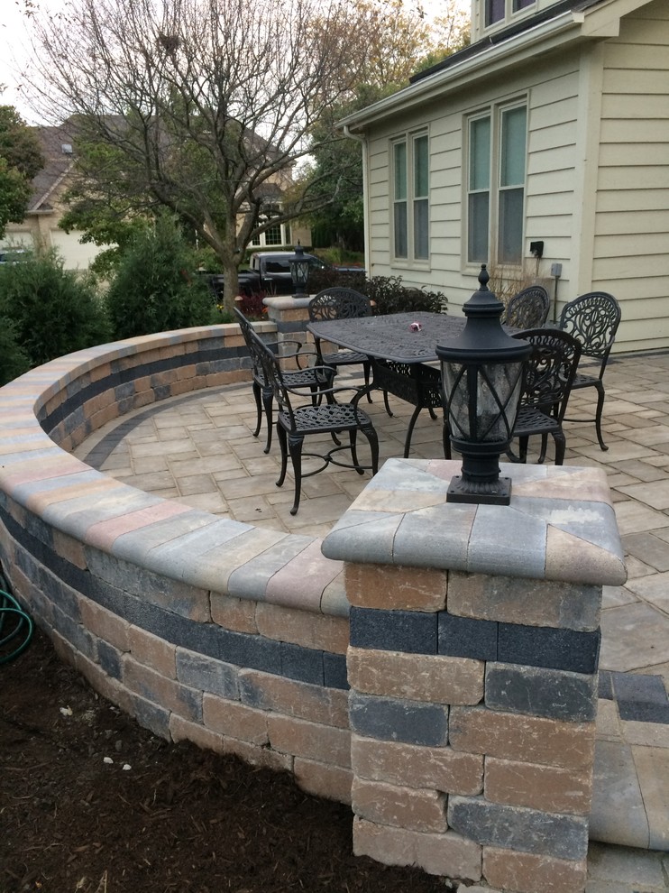 Photo of a medium sized classic back patio in Chicago with an outdoor kitchen, natural stone paving and no cover.