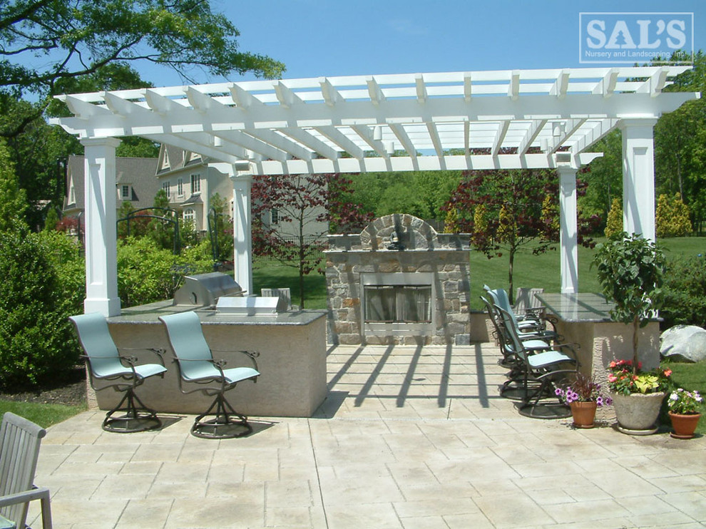 Inspiration for a large timeless backyard stone patio remodel in Philadelphia with a pergola