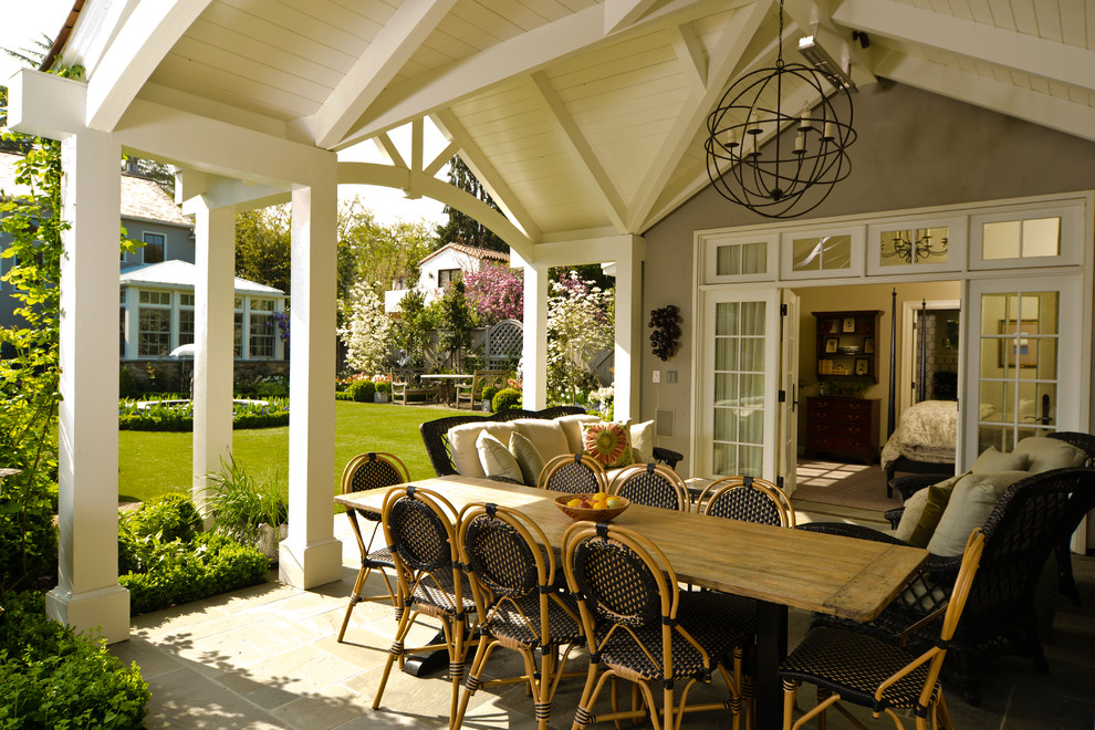 Example of a classic patio design in San Francisco with a roof extension