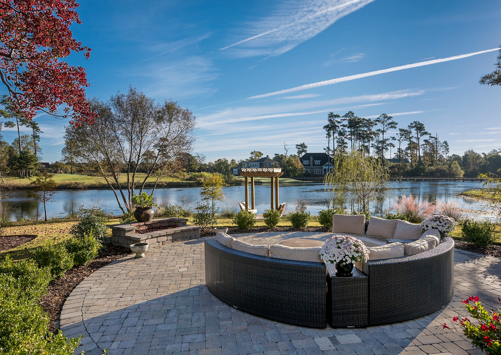 Design ideas for a classic patio in Raleigh with a water feature, brick paving and no cover.