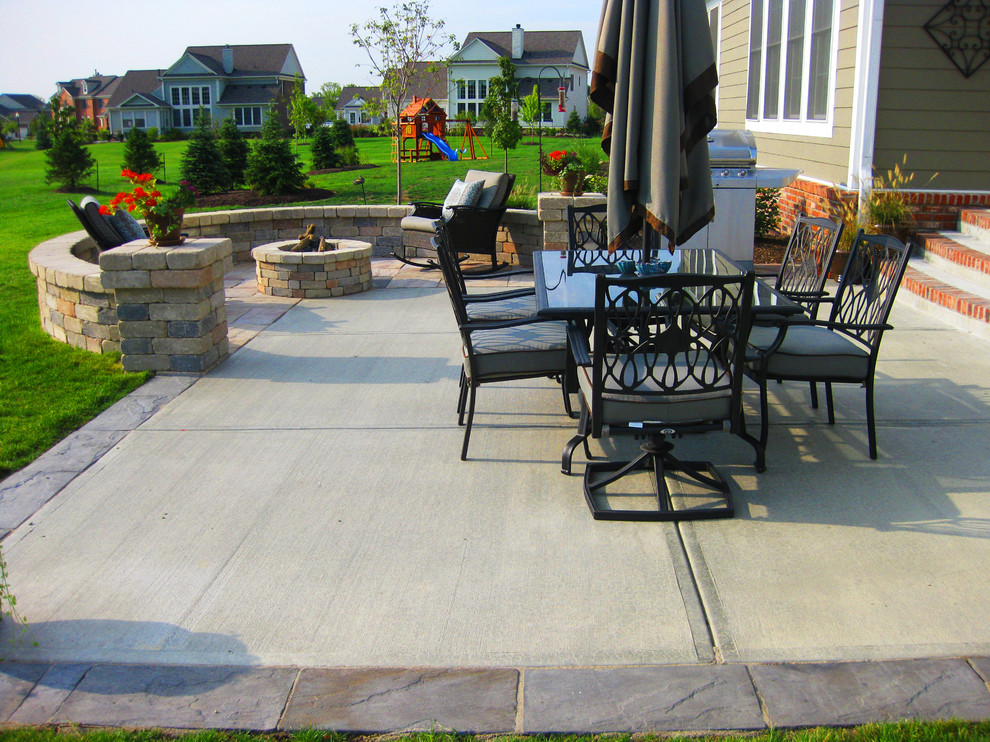 Patio - mid-sized traditional backyard concrete patio idea in Indianapolis with a fire pit and no cover
