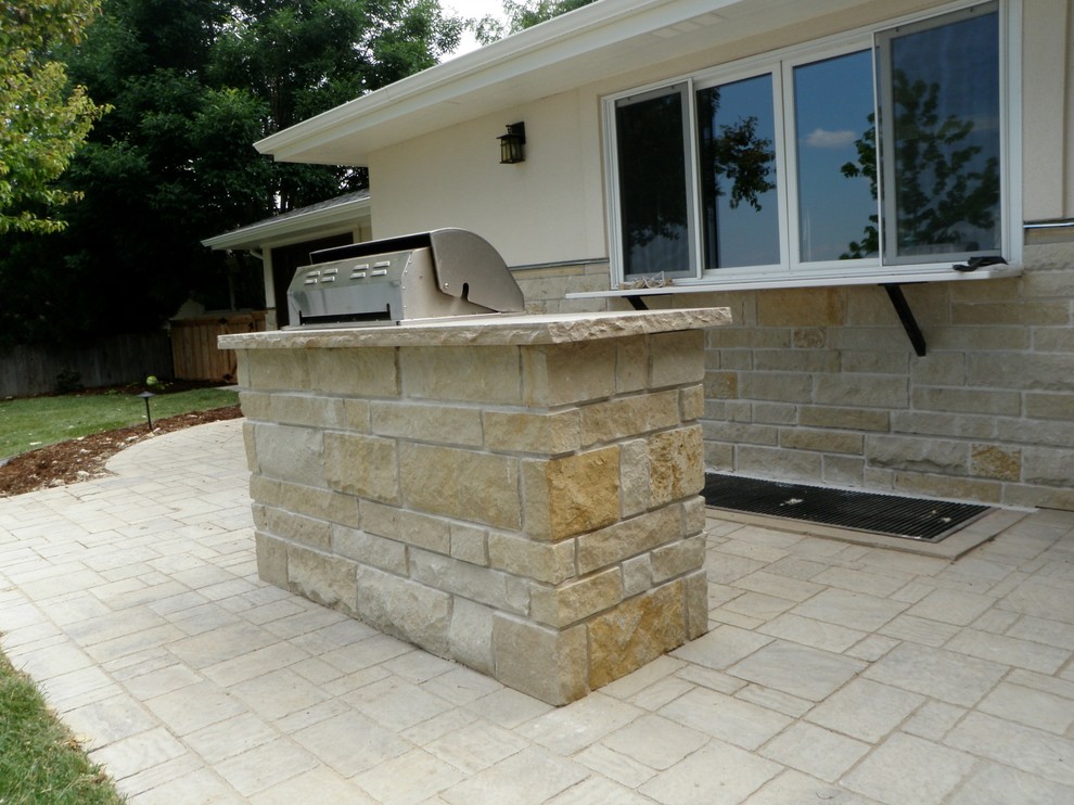 Traditional back patio in Denver with an outdoor kitchen and concrete paving.