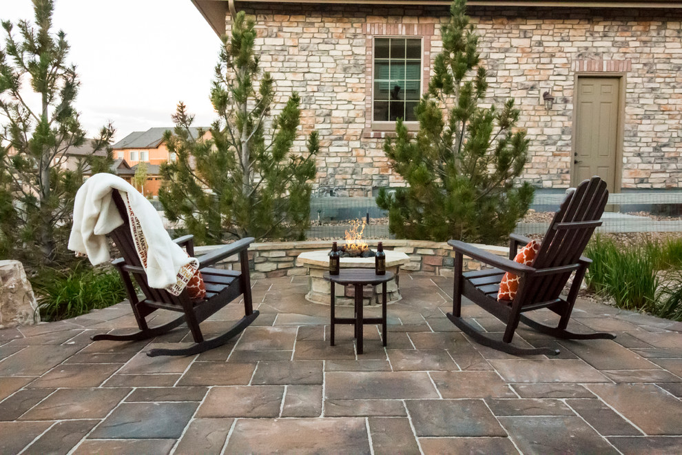 Design ideas for a rustic patio in Denver with a fire feature and brick paving.