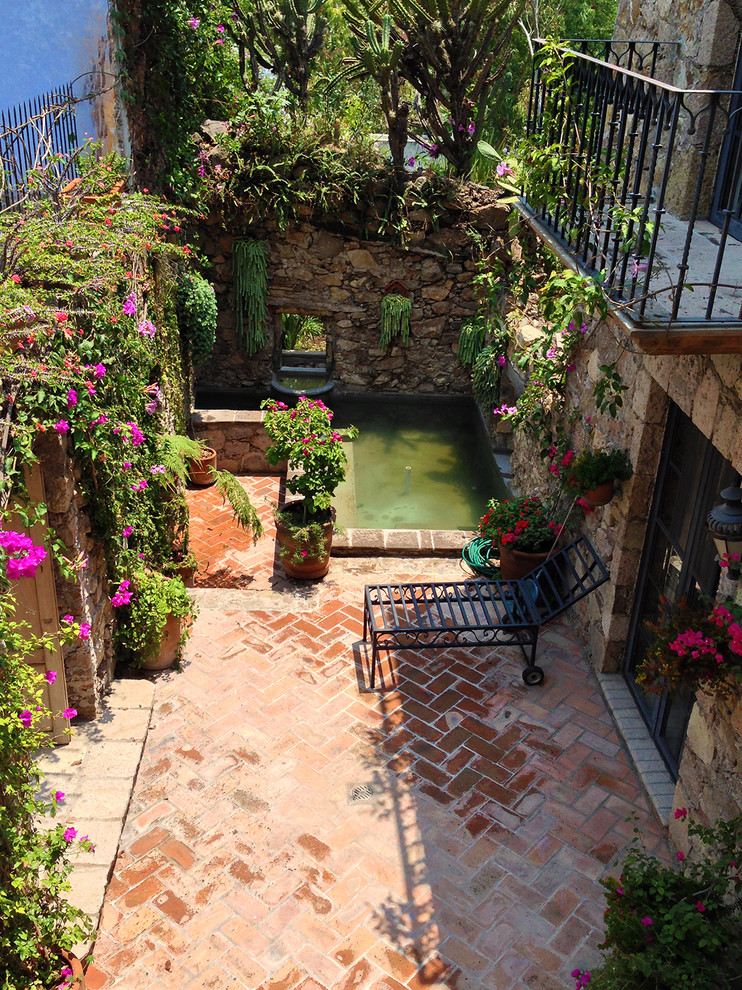 Inspiration for a mediterranean patio fountain remodel in Other