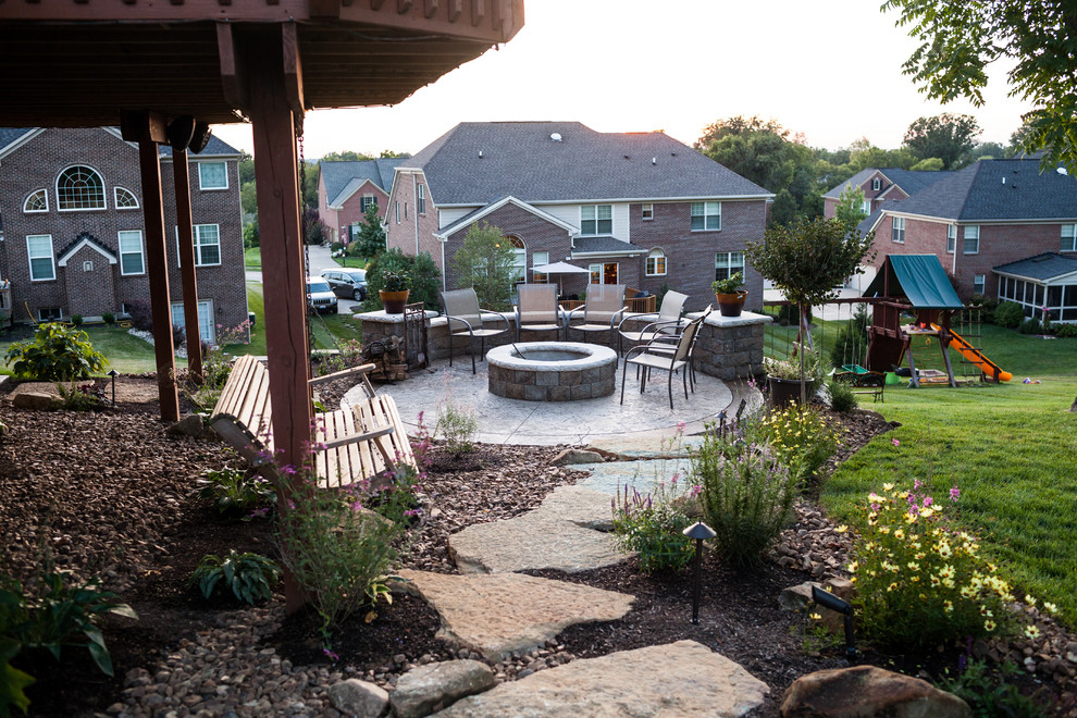 Example of a classic backyard stamped concrete patio design in Cincinnati