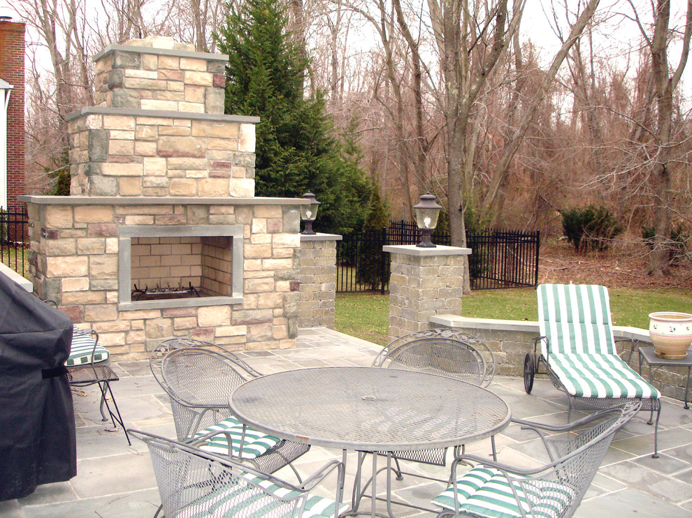 Design ideas for a medium sized classic back patio in Newark with a fire feature, natural stone paving and no cover.