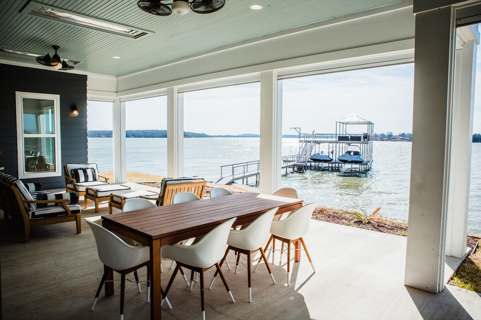 Inspiration for a large coastal backyard concrete patio remodel in Dallas with a fire pit and a roof extension