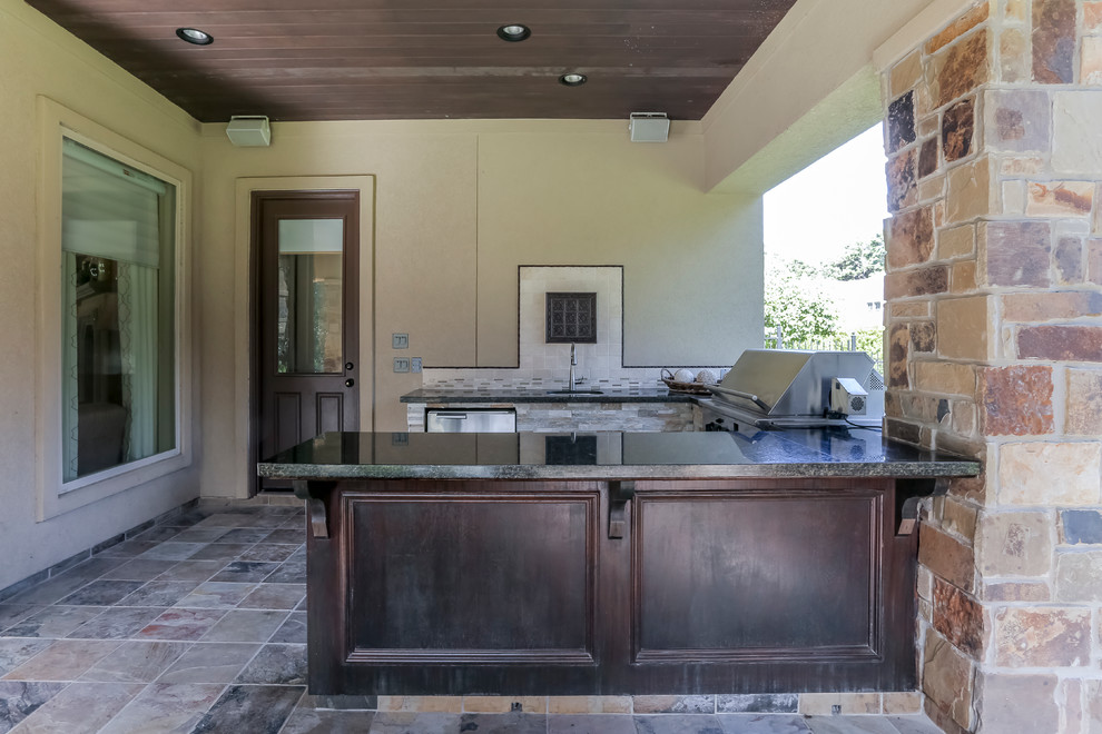 Photo of a large rustic back patio in Houston with an outdoor kitchen, tiled flooring and a roof extension.