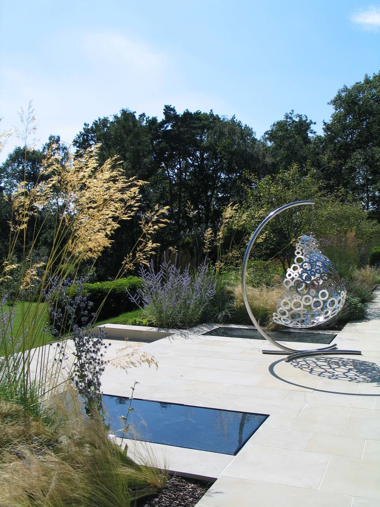 Design ideas for a contemporary patio in London with a water feature.