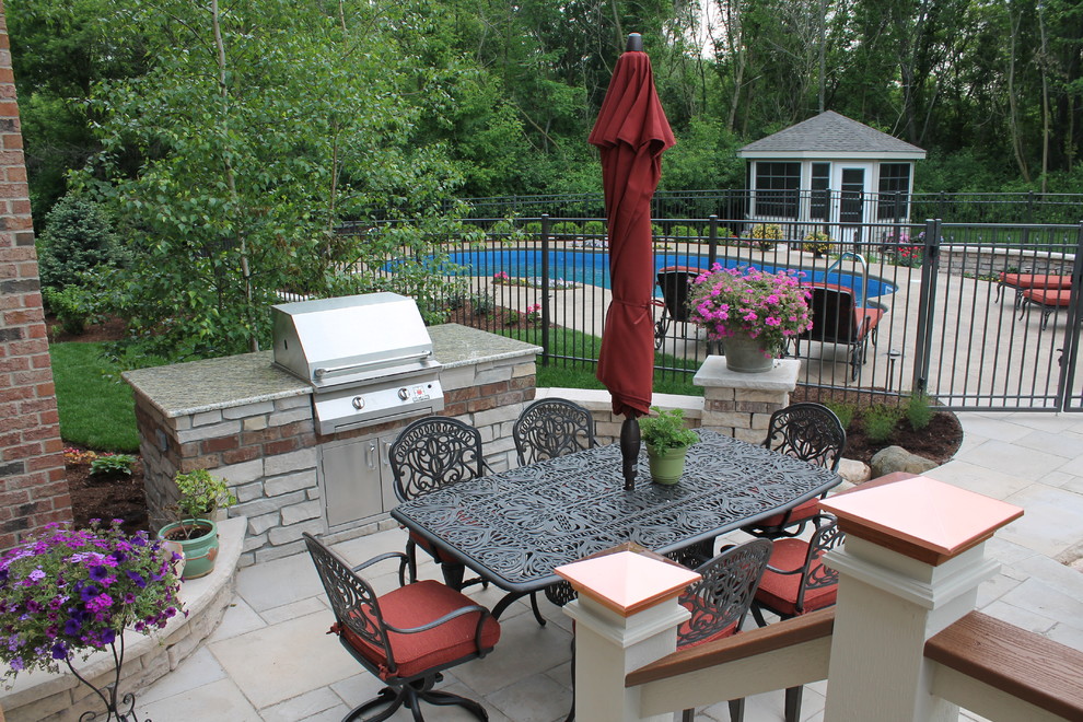 Mid-sized elegant backyard concrete paver patio kitchen photo in Chicago with no cover