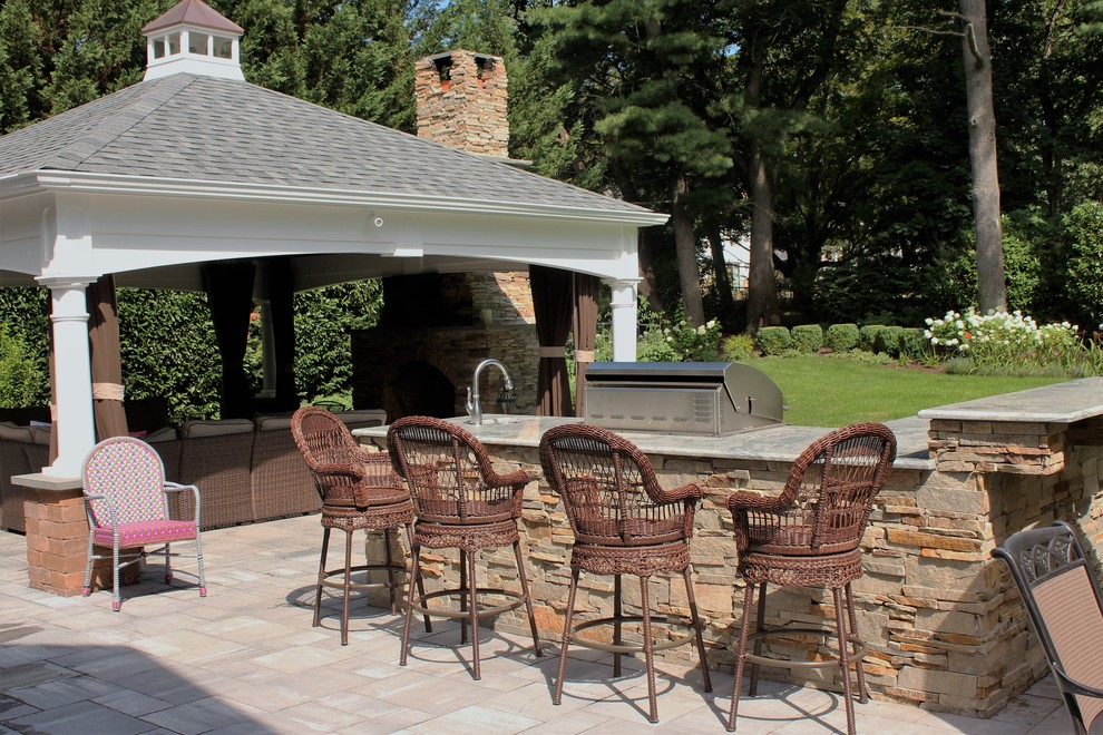 Patio - mid-sized transitional backyard concrete paver patio idea in New York with a fire pit and a gazebo