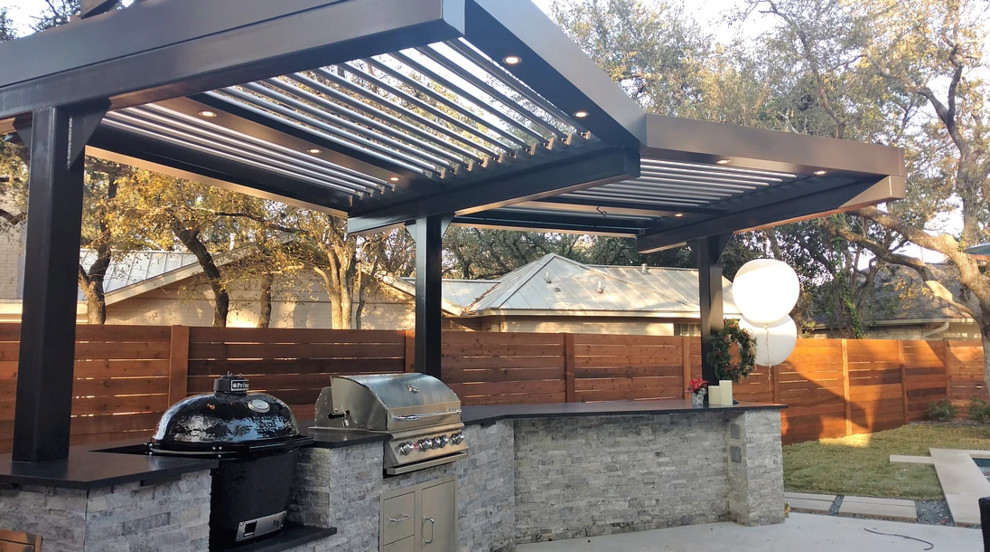 Medium sized traditional back patio in Miami with an outdoor kitchen, concrete slabs and a pergola.
