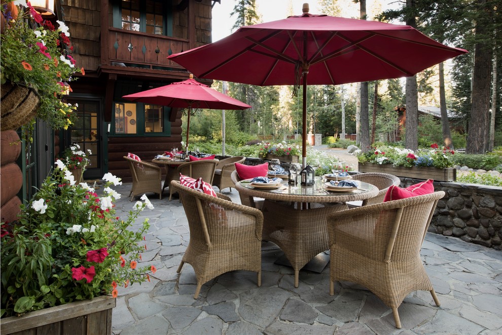Inspiration for a large rustic front patio in Sacramento with a potted garden, natural stone paving and no cover.