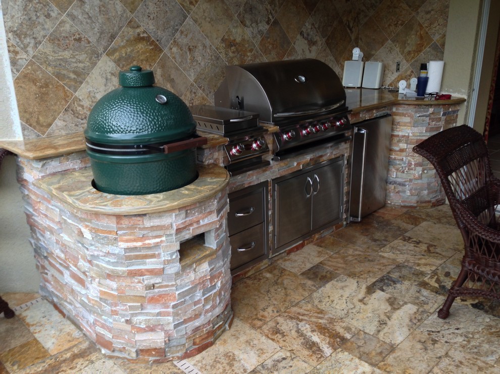 Example of a mid-sized classic backyard stone patio kitchen design in Tampa with a roof extension