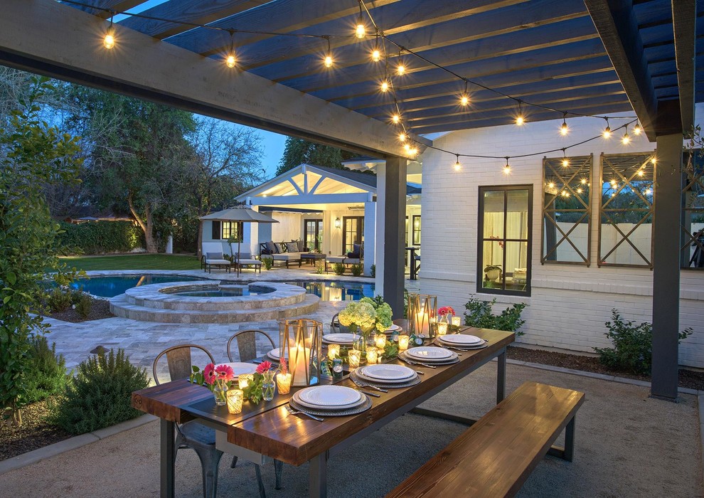 Inspiration for a large transitional backyard stone patio remodel in Phoenix with a pergola