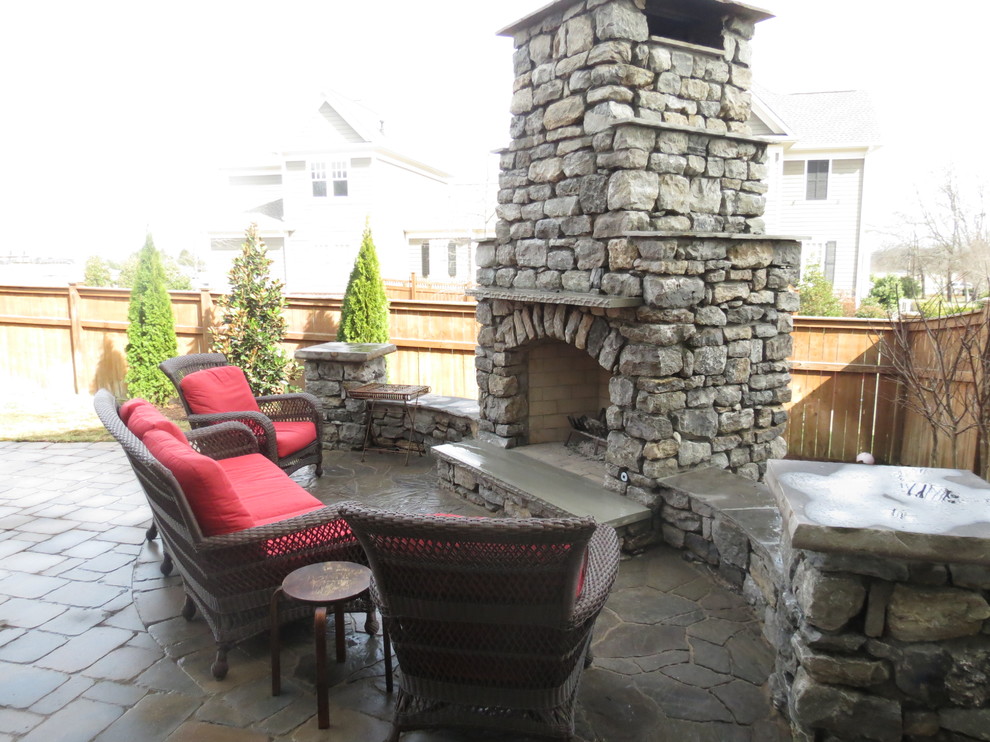 Inspiration for a large rustic back patio in Nashville with a fire feature, concrete paving and no cover.