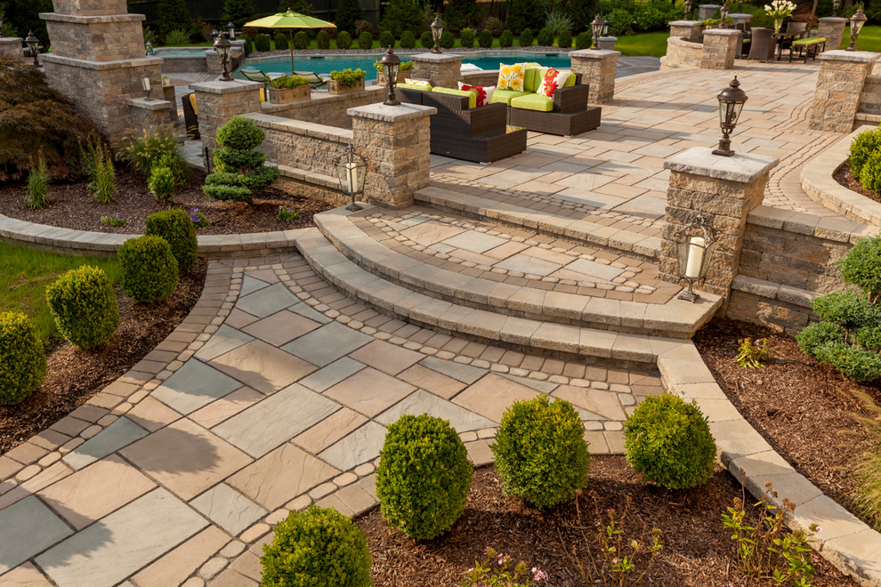 Inspiration for a large transitional backyard stone patio remodel in Boston with a gazebo and a fireplace