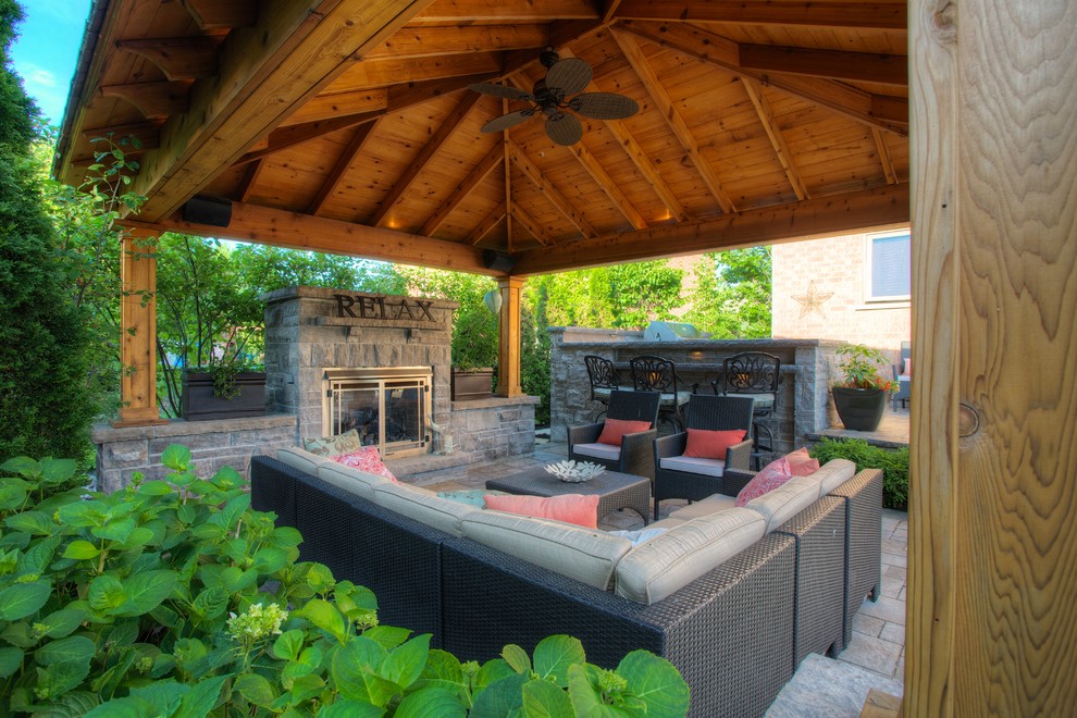 Elegant patio photo in Toronto with a fire pit and a gazebo